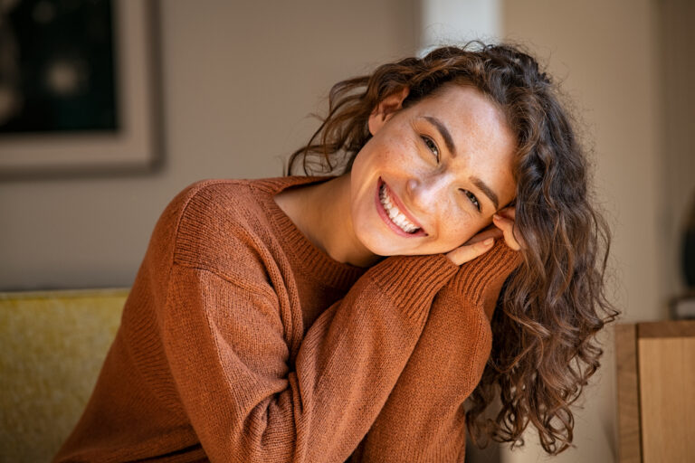 young lady wearing a sweater ready for fall with a nice smile